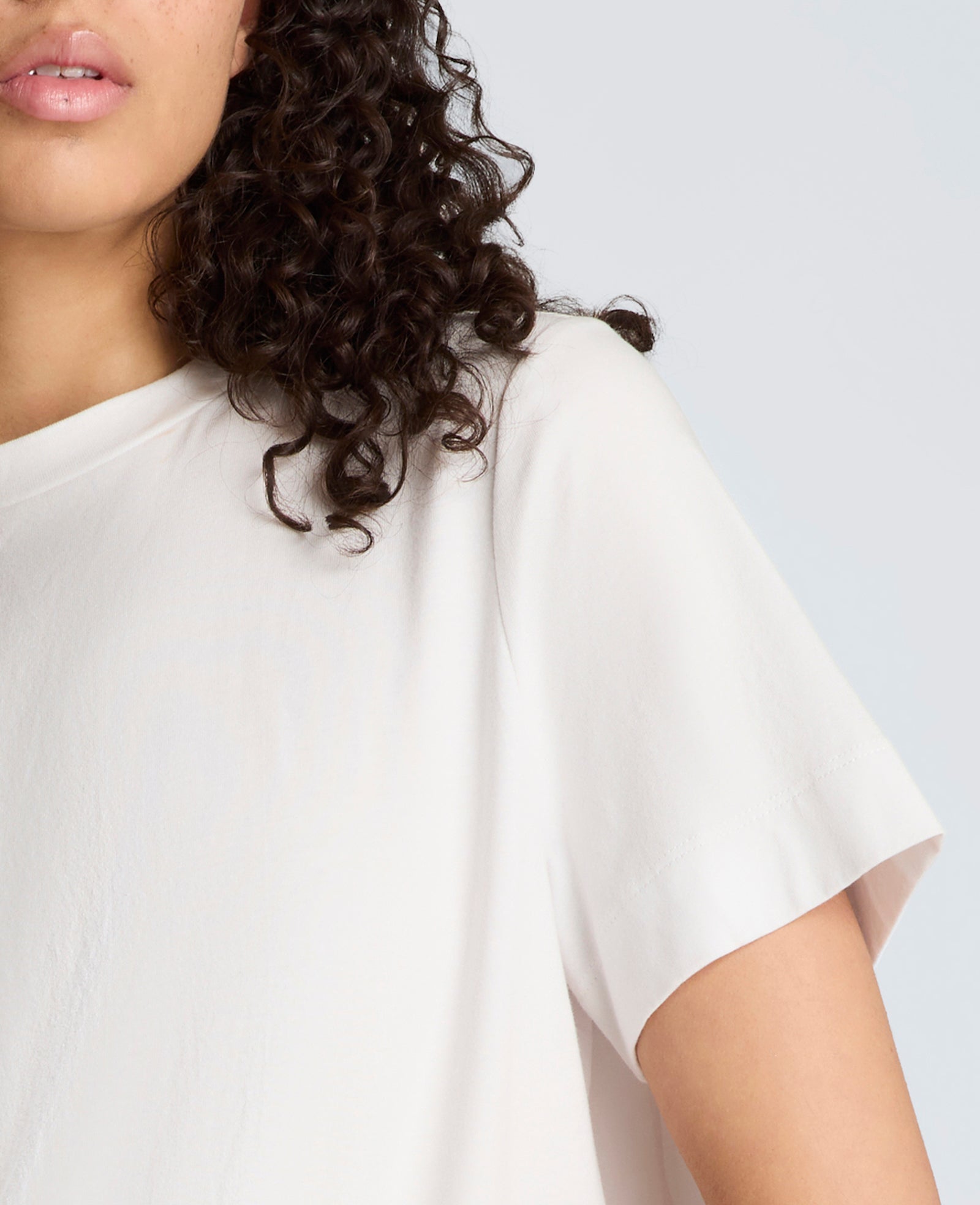 Short Sleeve Crewneck Tee with Pleated Asymmetrical Hem