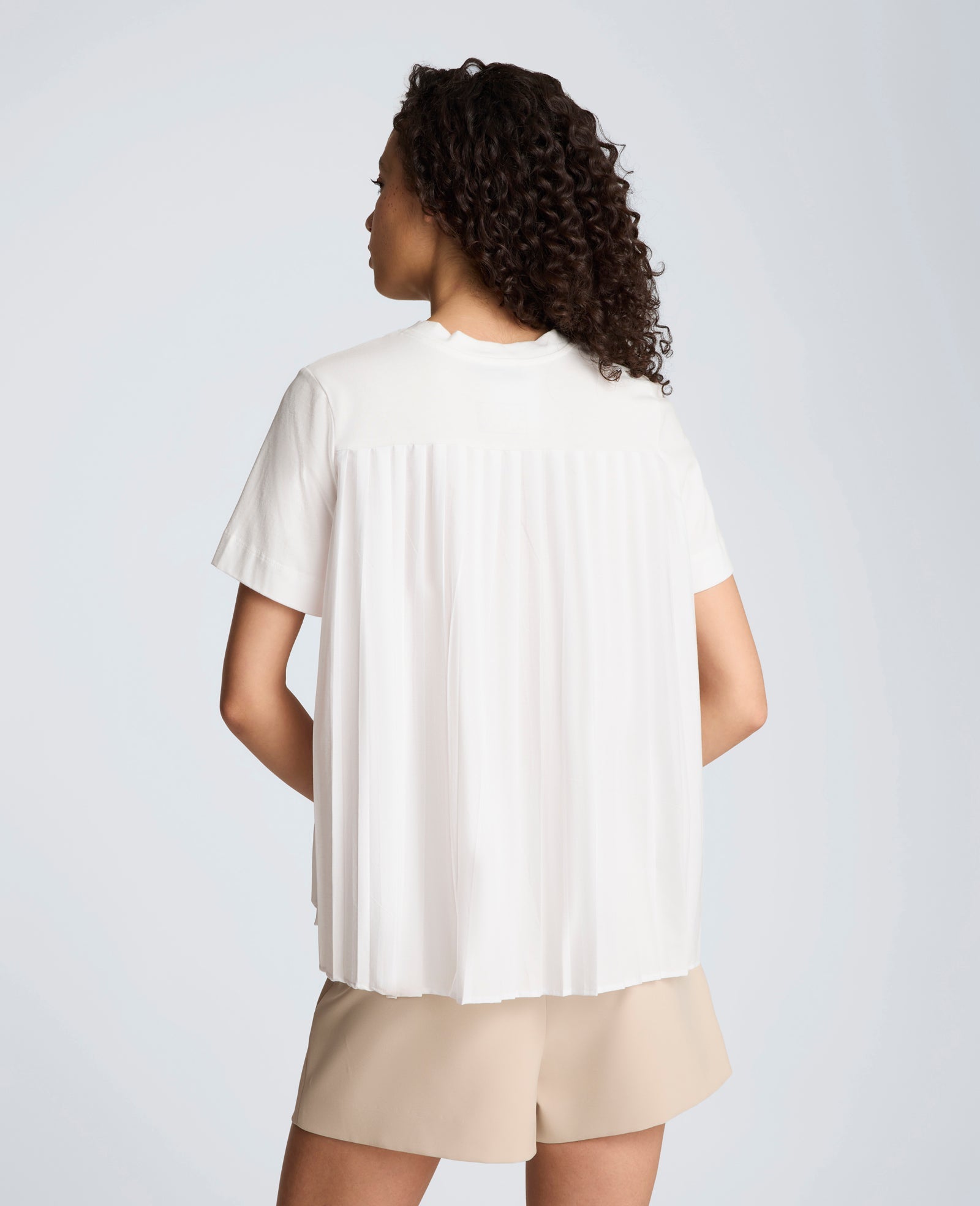 Short Sleeve Crewneck Tee with Pleated Asymmetrical Hem